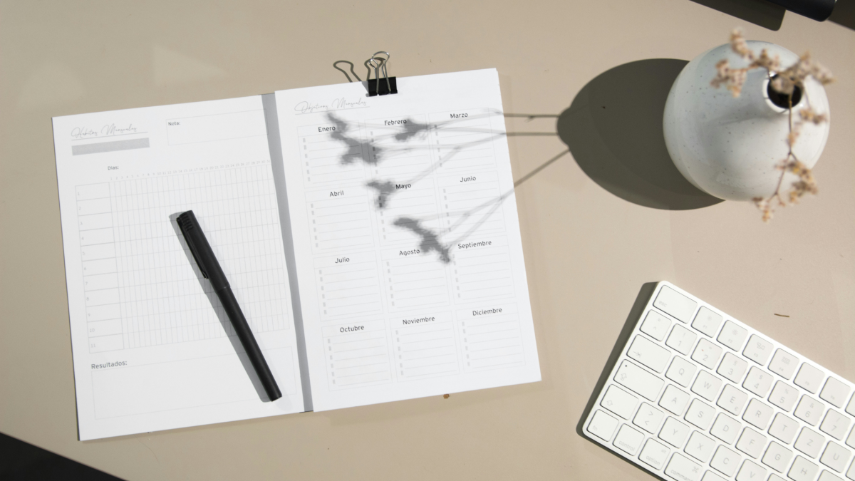 A printed calendar sits on a modern desk