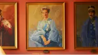 A row of paintings on a wall