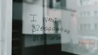 Someone has written 'I want $2000000' on a window in sharpie