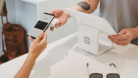 someone making a payment through google pay on their iphone