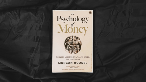 The book 'the psychology of money' against a black background