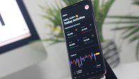 a phone shows a trading app