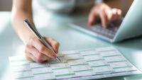 a woman writes in her calendar