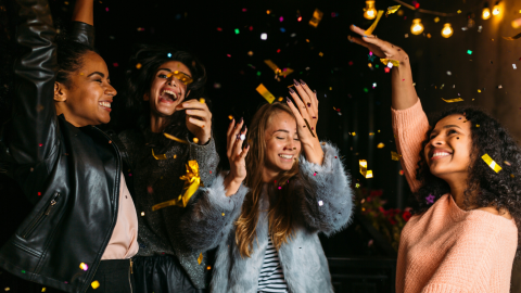 four women celebrating at a party