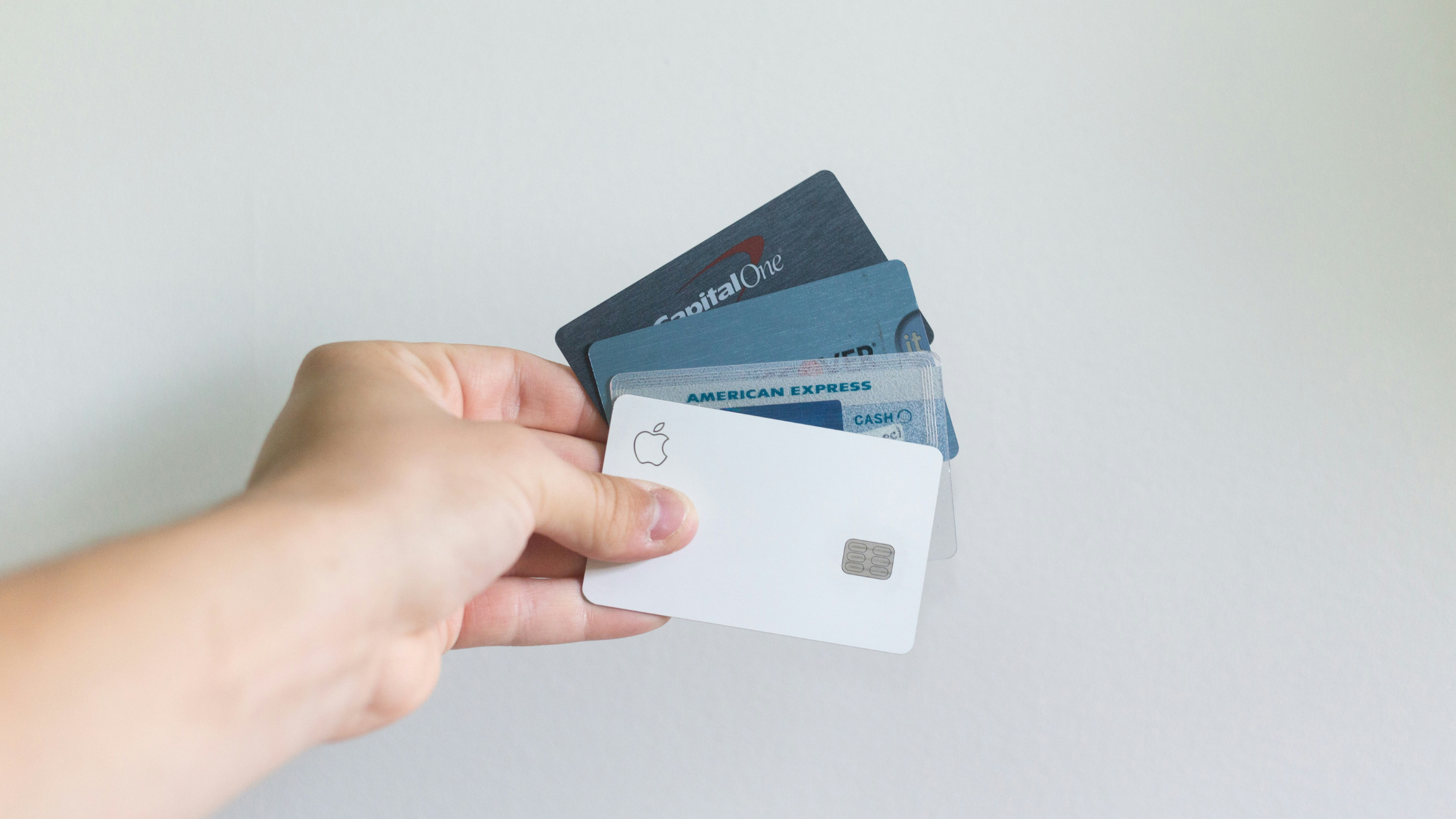 Someone holding a selection of credit cards