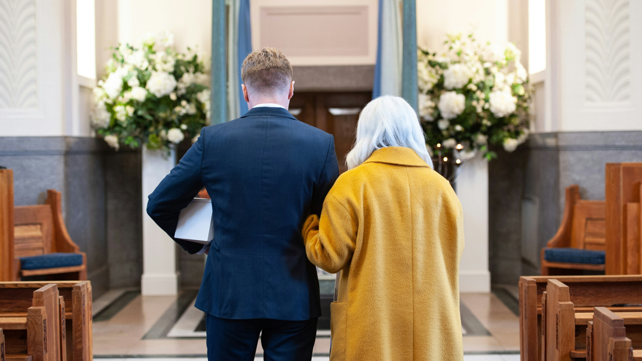 a man and elder relative attend a funeral