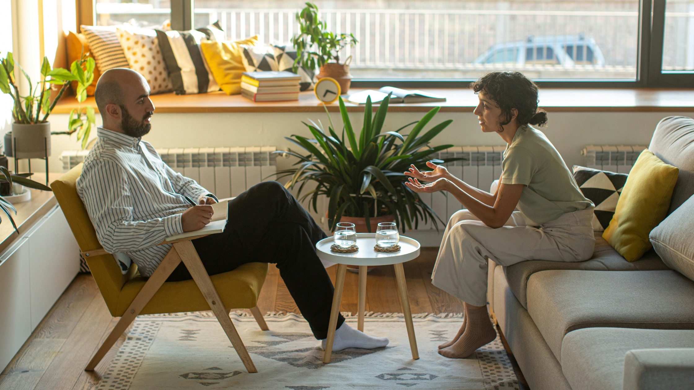 a man and woman talk in a well lit office