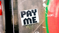 a sign in a window that says 'pay me'