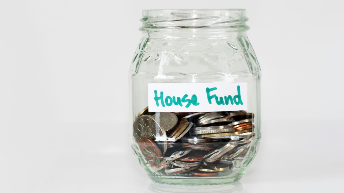 a glass jar labelled 'house fund'