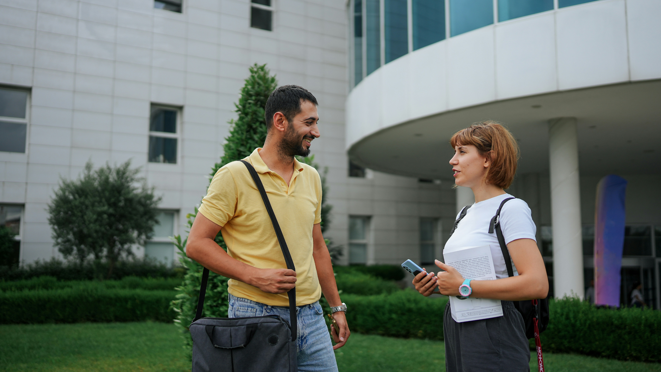 two students talk outside their university