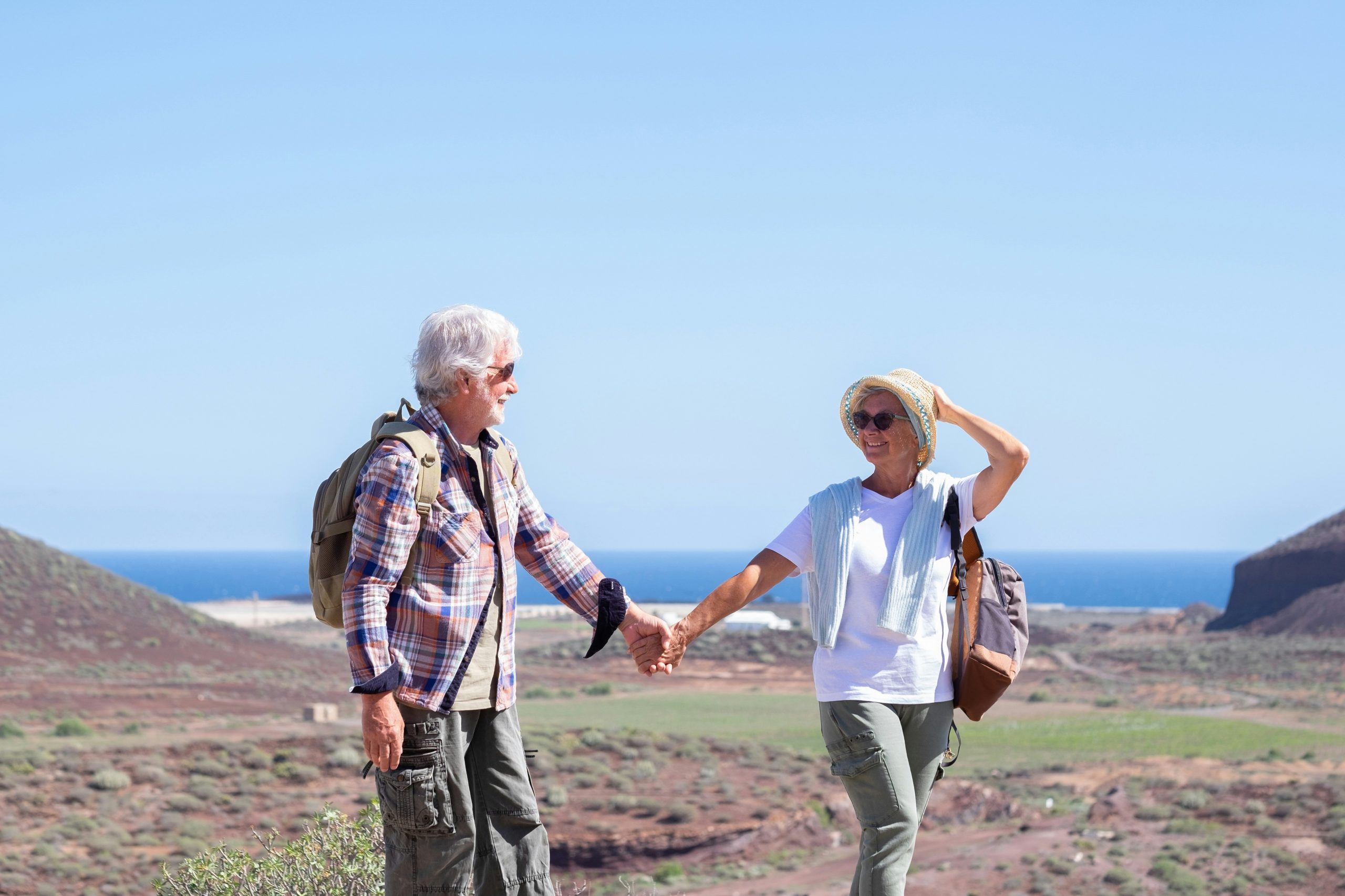 An older couple hold hands