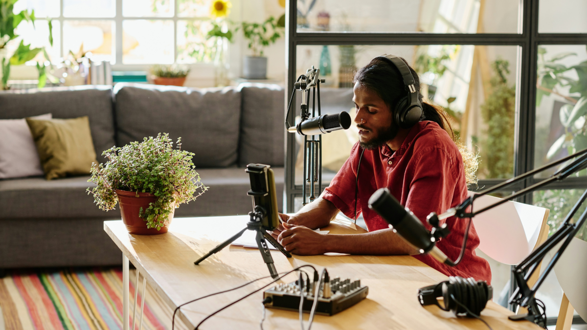 a stylish man is in his podcast studio