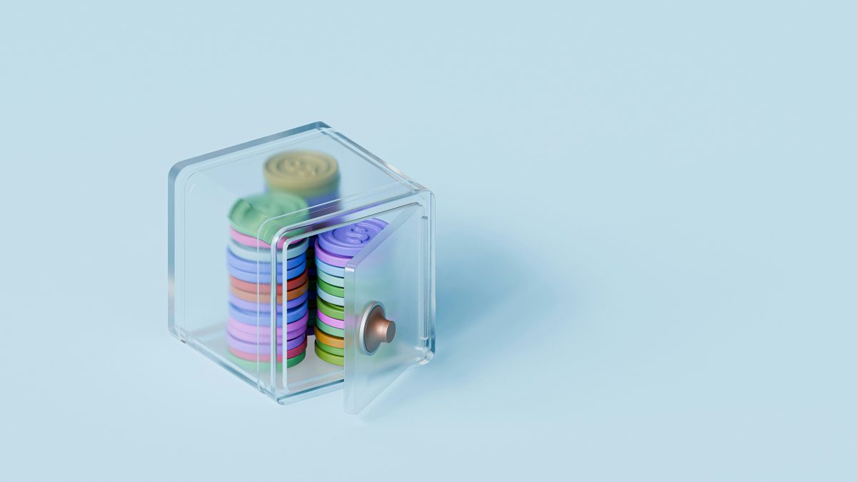 Colourful coins inside a tiny safe