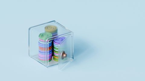 Colourful coins inside a tiny safe