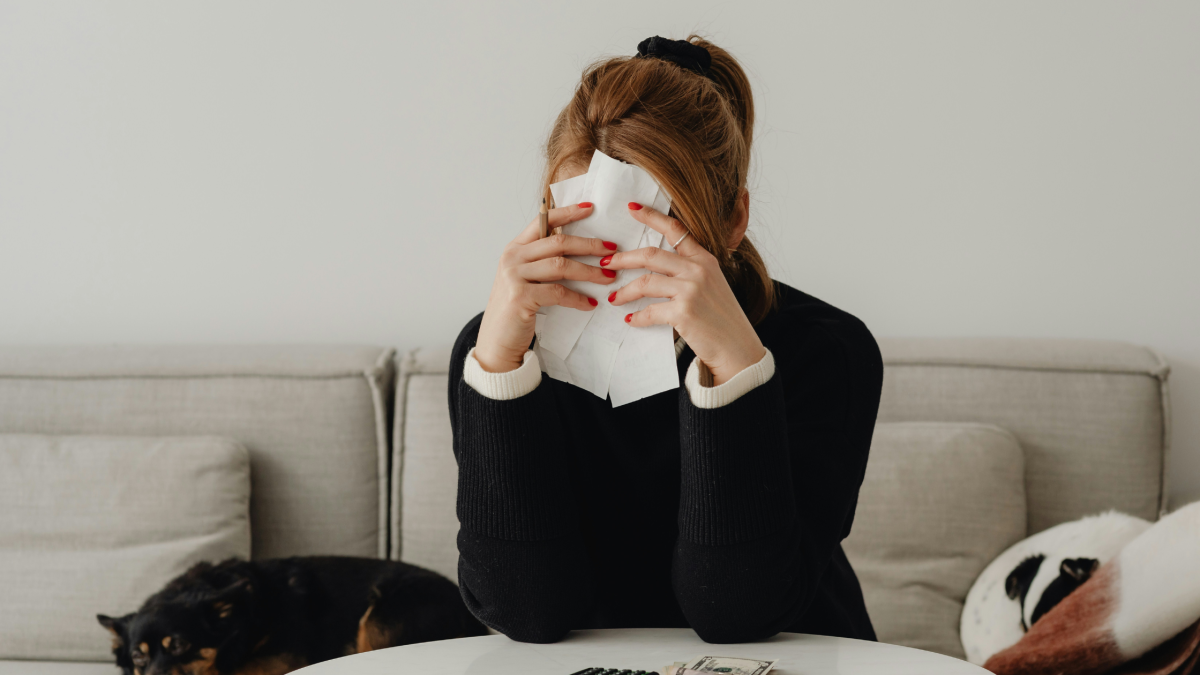 a frustrated looking woman holding receipts