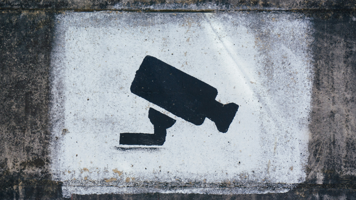 graffiti on a wall of a security camera