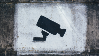 graffiti on a wall of a security camera