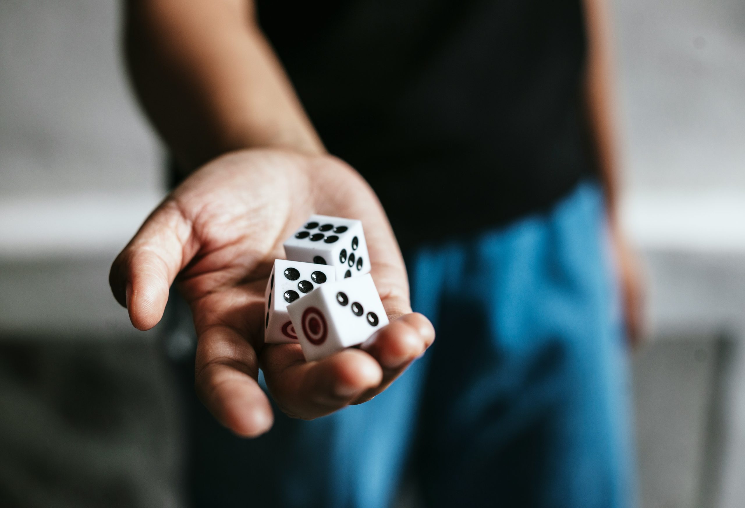 A man holds dice in his hand