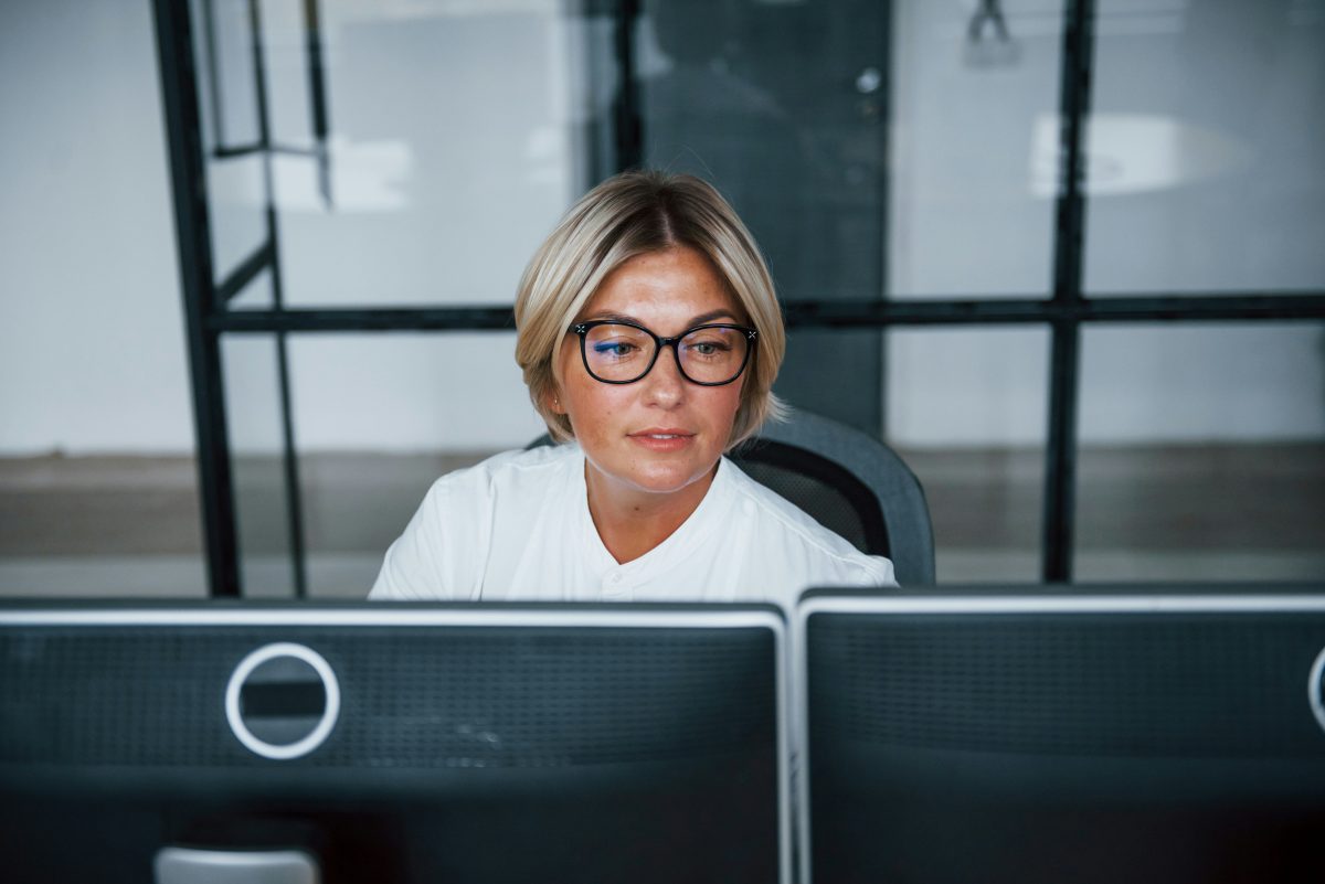 A woman sits at an office desk