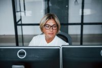 A woman sits at an office desk