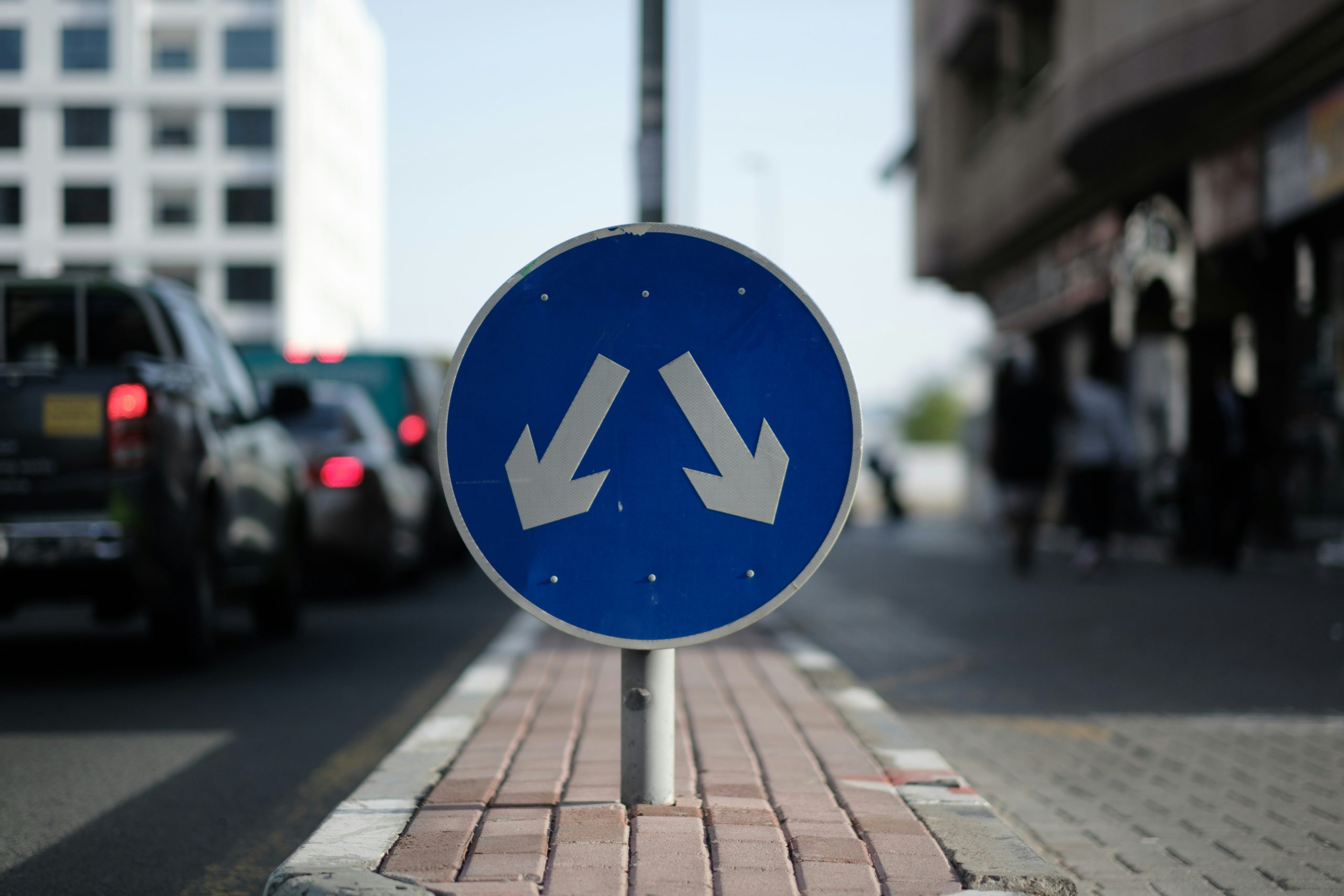 A road sign with arrows going in two different directions