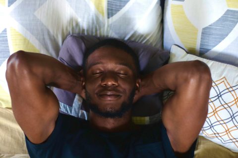 A man lays back, looking calm