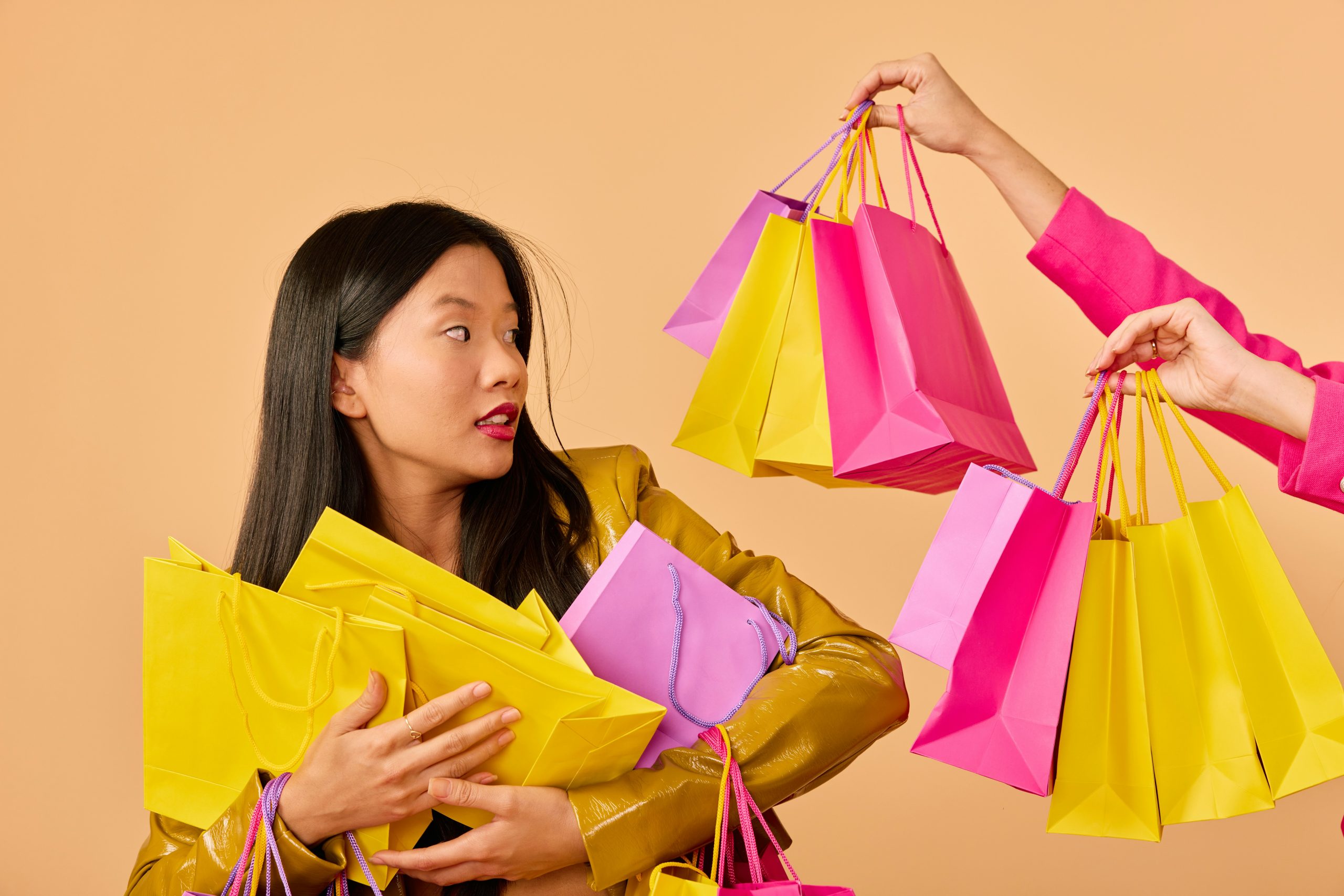A young woman holds lots of shopping bags