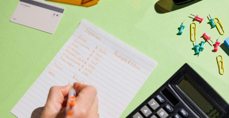 A modern desk with someone planning their budget