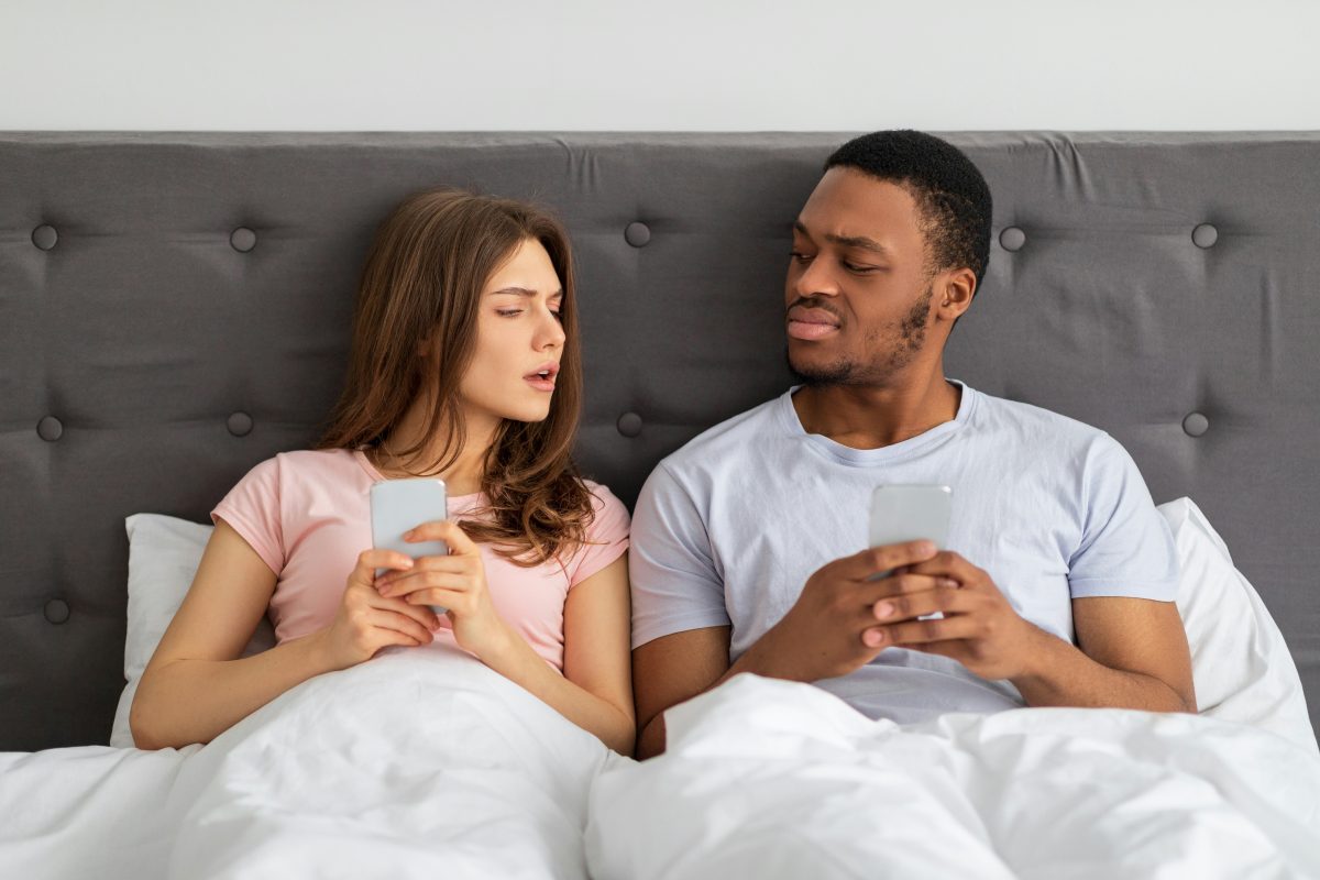 A young couple sits in bed
