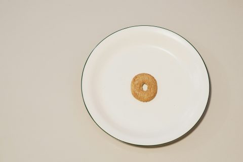 A single cheerio in a bowl.