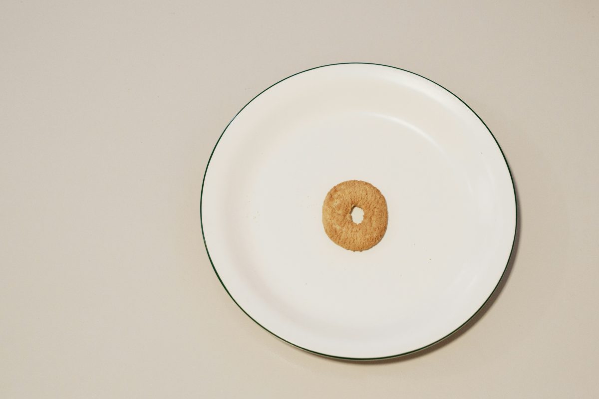 A single cheerio in a cereal bowl