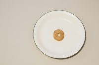 A single cheerio in a cereal bowl