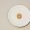 A single cheerio in a cereal bowl
