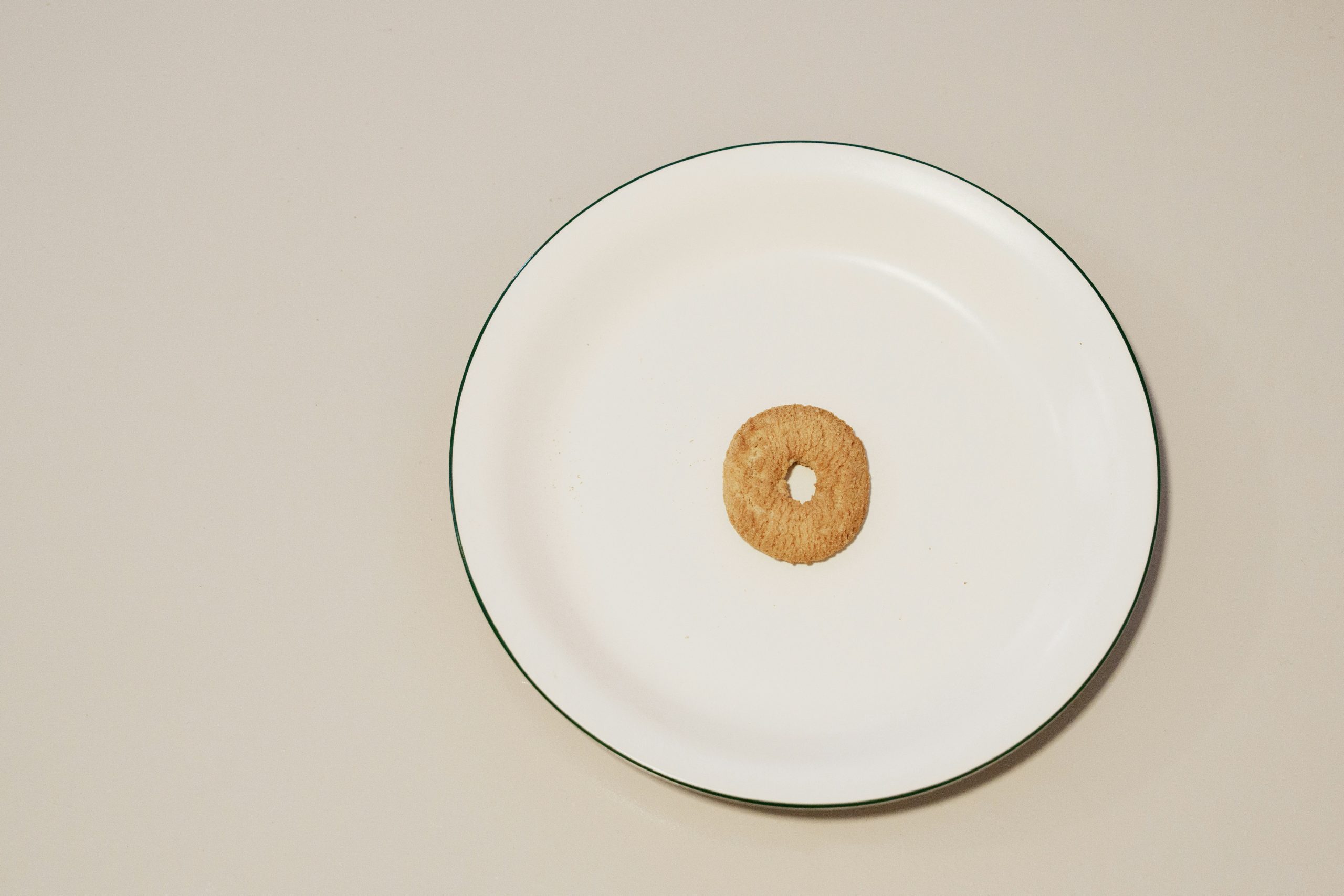 A single cheerio in a cereal bowl